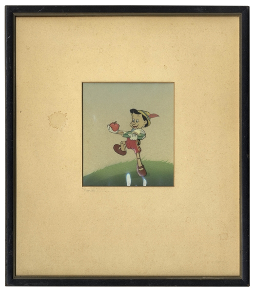 ''Pinocchio'' Animation Cel From the 1940 Disney Classic Film, Showing Pinocchio Holding the Apple for His Teacher -- With Hand Painted Set-up by Courvoisier