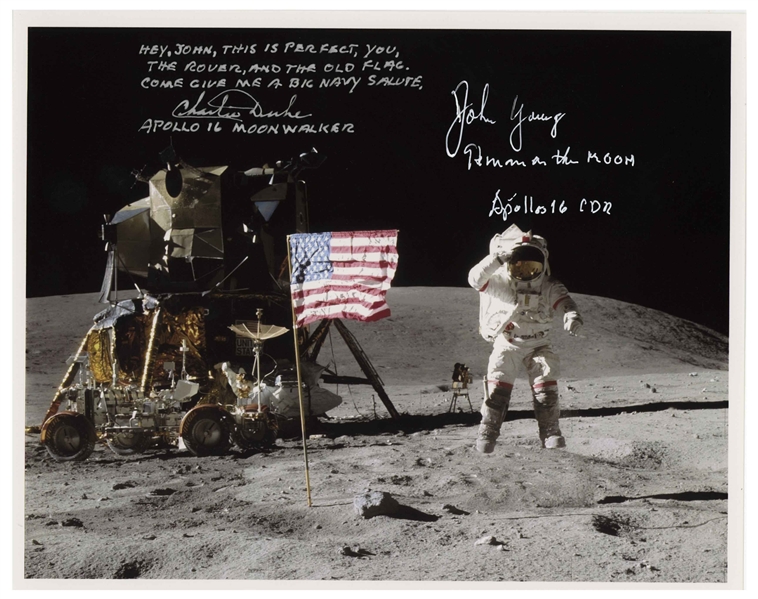John Young and Charlie Duke Signed 10'' x 8'' Lunar Photo of Young Saluting the U.S. Flag During the Apollo 16 Mission -- Duke Additionally Writes, ''Hey, John...Come give me a big Navy salute''