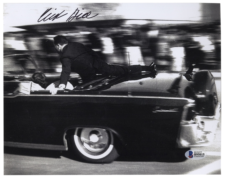 Clint Hill Signed 10'' x 8'' Photo, Showing Hill Heroically Shielding President John F. Kennedy and the First Lady -- With Beckett's Authentication