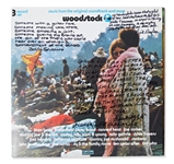 Woodstock Album Signed by Photographer Burk Uzzle & the Iconic Couple -- ...Someone with a guitar here, someone making love there, someone smoking a joint...a bombardment of the senses...