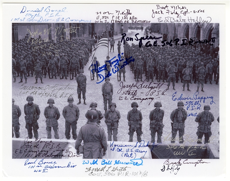 Photo Signed by 17 Soldiers of ''Easy Company'', AKA the Band of Brothers, at the Battle of Carentan Awards Ceremony -- Includes Company Commander Dick Winters Who Writes His Motto ''Hang Tough''