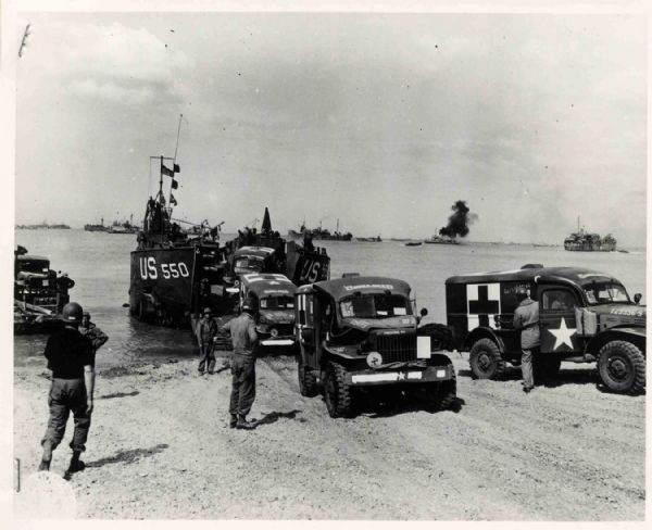 Original World War II 10'' x 8'' Black and White Glossy Wire Photo -- Ferry Unloads Army Ambulances on French Beach -- Near Fine
