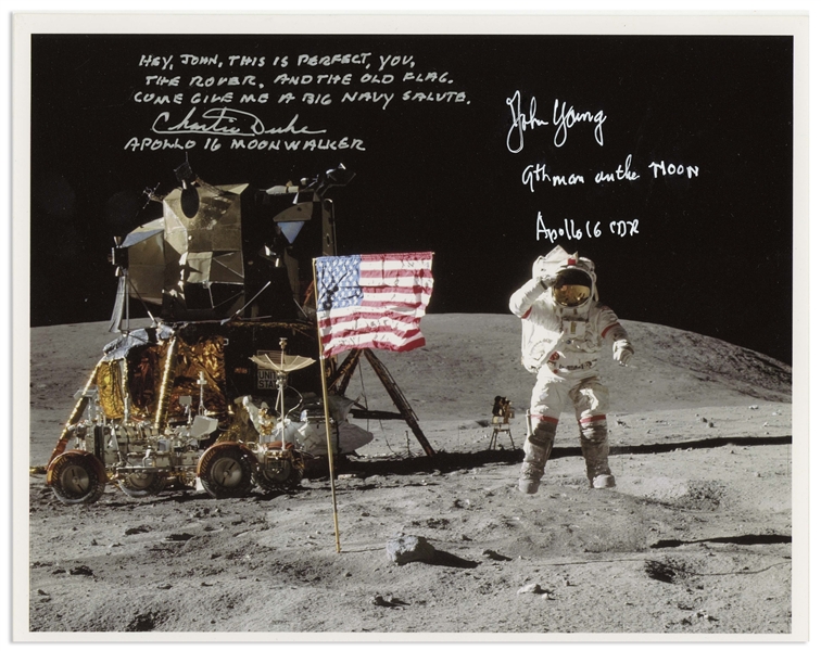 John Young and Charlie Duke Signed 10'' x 8'' Lunar Photo of Young Saluting the U.S. Flag During the Apollo 16 Mission -- Duke Additionally Writes, ''Hey John...Come give me a big Navy salute''