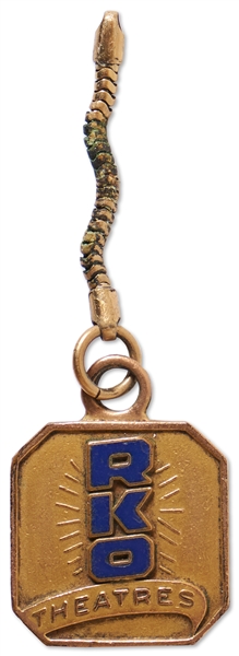 Gold Tone & Blue Enamel RKO Theatres Keychain Engraved on Back: ''To Theater Managers Please Extend Courtesy of This Theater to Moe Howard and Party'' -- Measures .875'' Square Excluding Chain -- Rare