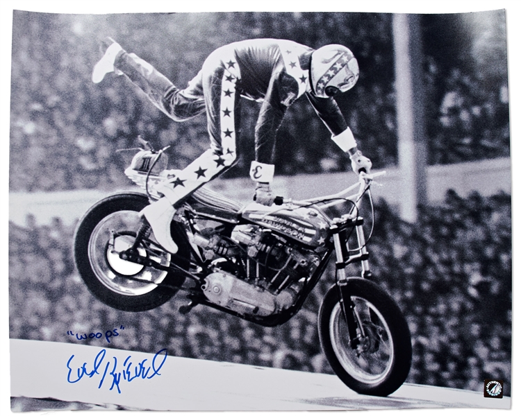 Evel Knievel Signed 20'' x 16'' Photo of His Famous Wembley Stadium Jump -- Knievel Also Writes ''Woops''
