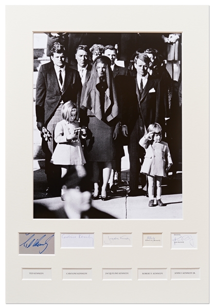 The Kennedy Family Signed Display Showing JFK Jr. Saluting His Fathers Casket -- Signed by Jackie, Caroline, John Jr., Ted and Bobby Kennedy -- With PSA/DNA COAs for All, Measures 21.75 x 31.75
