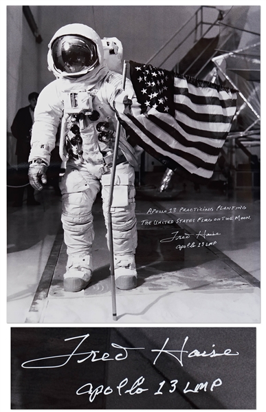 Gorgeous 20'' x 16'' Photo of James Lovell in His White Spacesuit with the U.S. Flag -- Signed by Apollo 13 LMP Fred Haise Who Writes, ''Apollo 13 Practicing Planting the American Flag on the Moon''