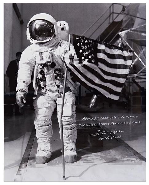 Gorgeous 20'' x 16'' Photo of James Lovell in His White Spacesuit with the U.S. Flag -- Signed by Apollo 13 LMP Fred Haise Who Writes, ''Apollo 13 Practicing Planting the American Flag on the Moon''