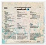 Woodstock Album Signed by Photographer Burk Uzzle & the Iconic Couple -- Someone with a guitar here, someone making love there, someone smoking a joint...a bombardment of the senses